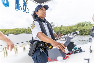 female officer steering boat