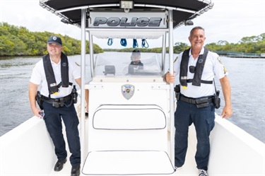 male officers scouting horizon from boat