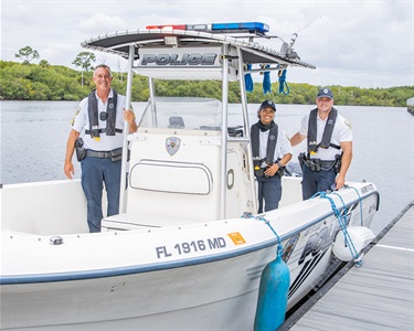 Marine Unit Police Officers smiling in boat