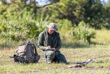 swat kneeling with equipment