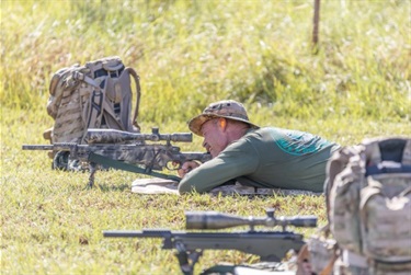 SWAT aiming next to backpack