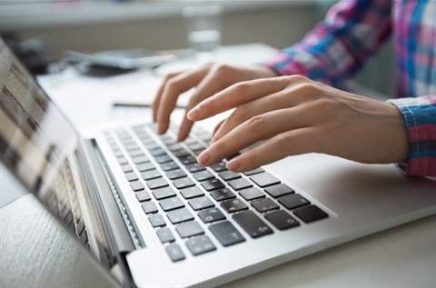 computer hands typing laptop online