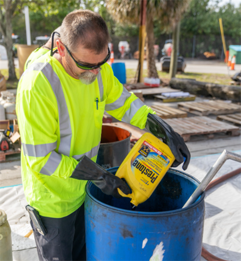 staff disposing household hazardous waste