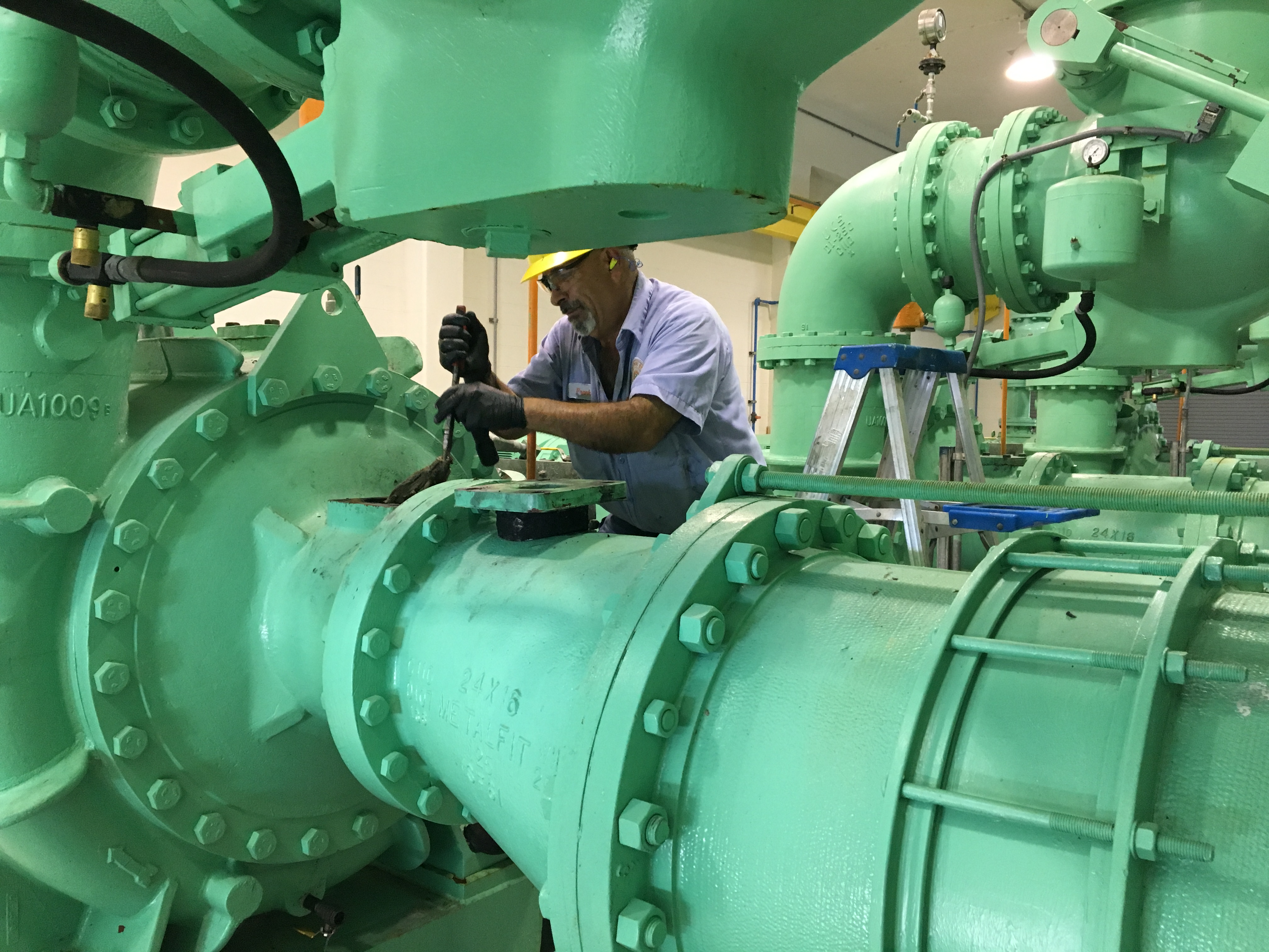 employee maintaining wastewater booster station