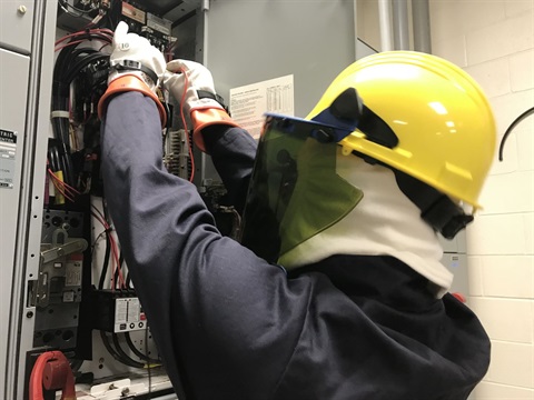 employee opening electrical panel