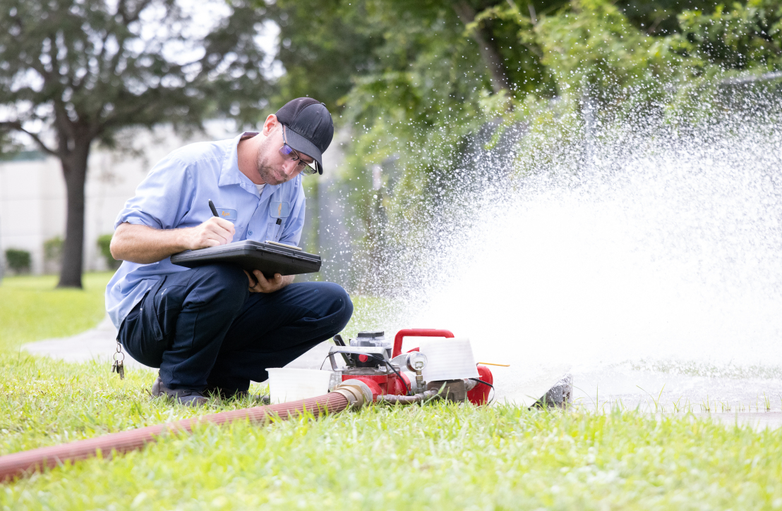 Utility Systems employee working with water