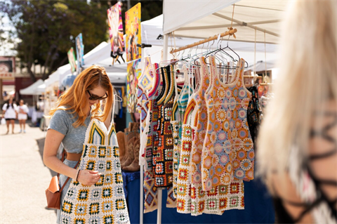 Woman looking at clothes at an outdoor event